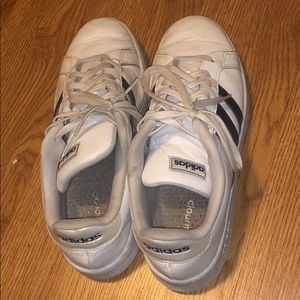 Adidas sneakers with blue stripes